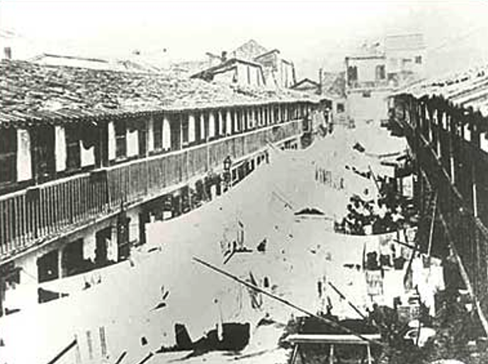 A street with buildings in the background

Description automatically generated
